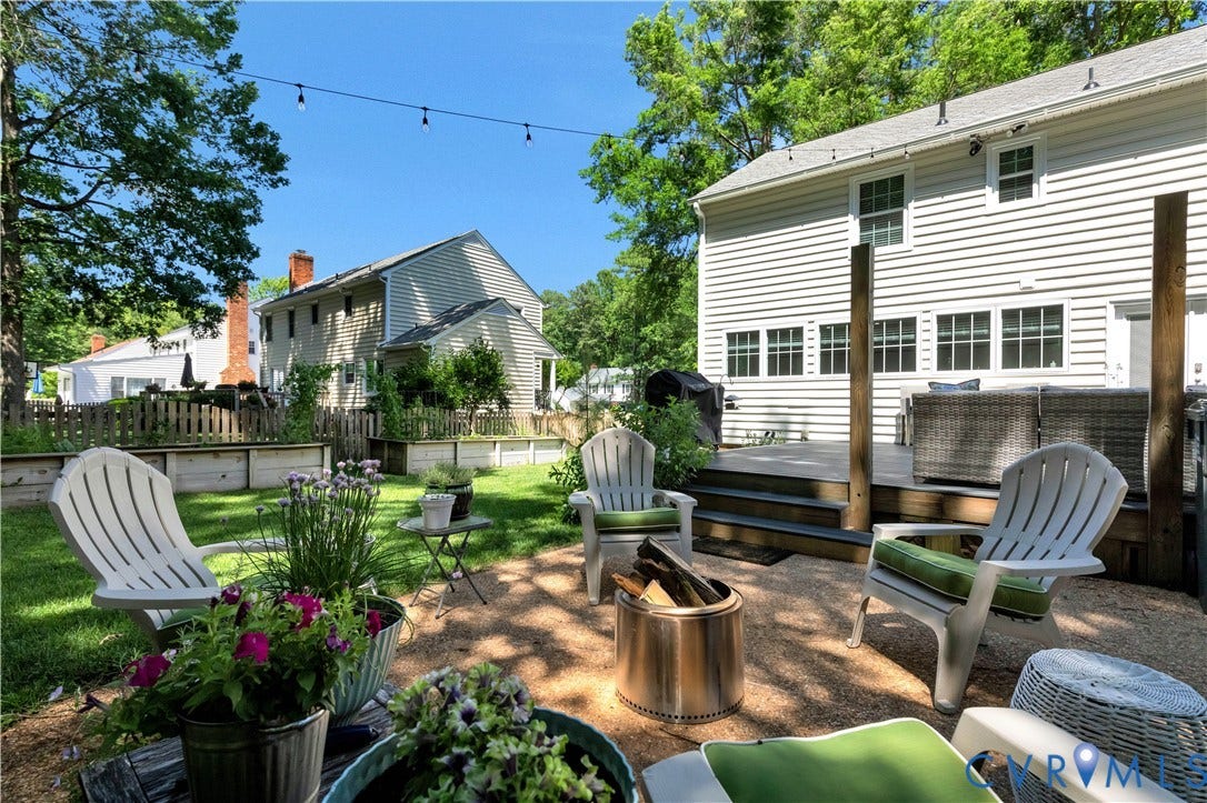 10100 Contessa Court, Glen Allen, VA 23060 Expansive backyard featuring a multi-level deck with steps, a gravel patio area, and a lush green lawn