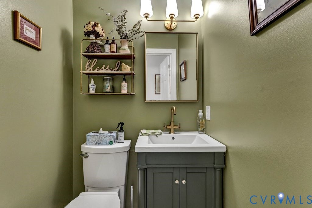 10100 Contessa Court, Glen Allen, VA 23060 Bathroom featuring a modern vanity with a white basin, brass-finish faucet, and a coordinating mirror