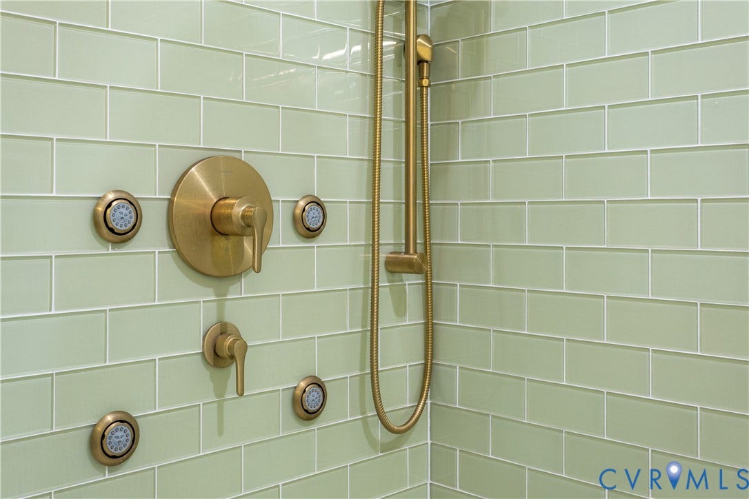 10100 Contessa Court, Glen Allen, VA 23060 Shower with light green subway tile, brushed gold fixtures, a handheld showerhead, and multiple body sprays