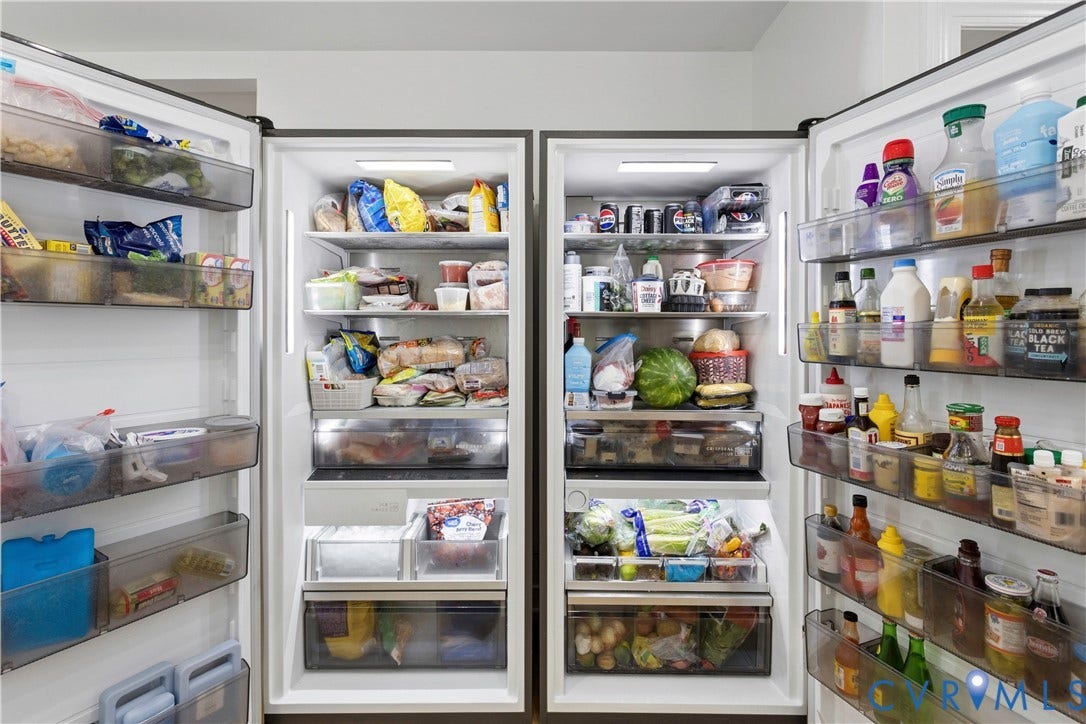 10100 Contessa Court, Glen Allen, VA 23060 Integrated full-size refrigerator and freezer units featuring interior lighting, transparent door bins, multiple adjustable shelves, and bottom drawer storage