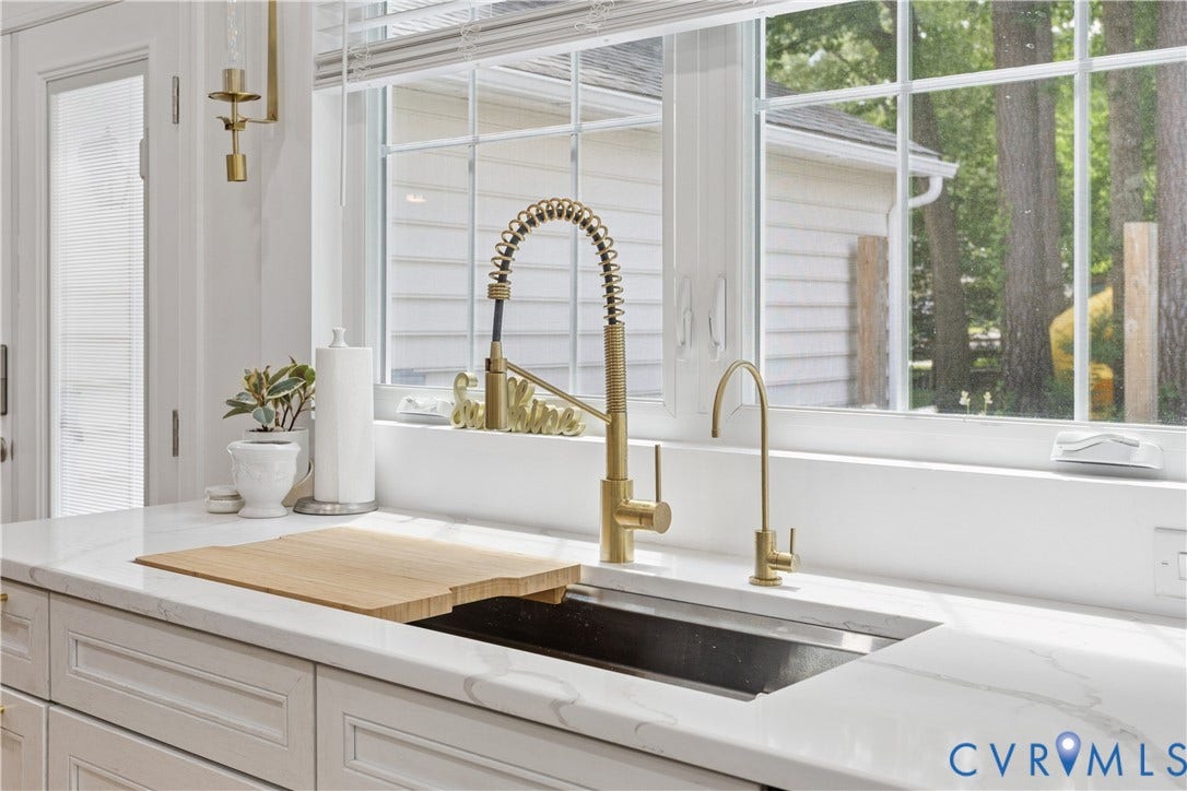 10100 Contessa Court, Glen Allen, VA 23060 Kitchen sink area featuring a large window, light-toned cabinetry, and sleek countertops