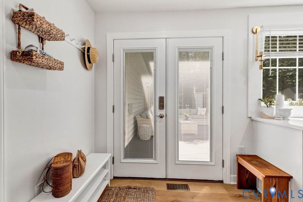 10100 Contessa Court, Glen Allen, VA 23060 French doors featuring glass panels, wood-finish flooring, a white window trim, and a window with blinds