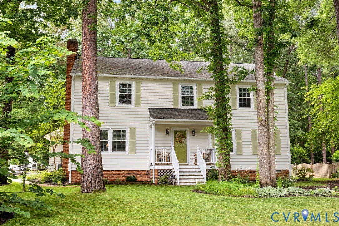 10100 Contessa Court, Glen Allen, VA 23060 Two-story residential exterior featuring light-colored siding, contrasting light green shutters, and a front porch with white railing