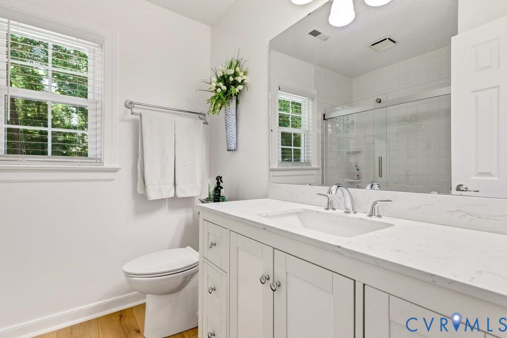 10100 Contessa Court, Glen Allen, VA 23060 Bathroom featuring a dual-sink vanity with white cabinetry and a light-colored countertop