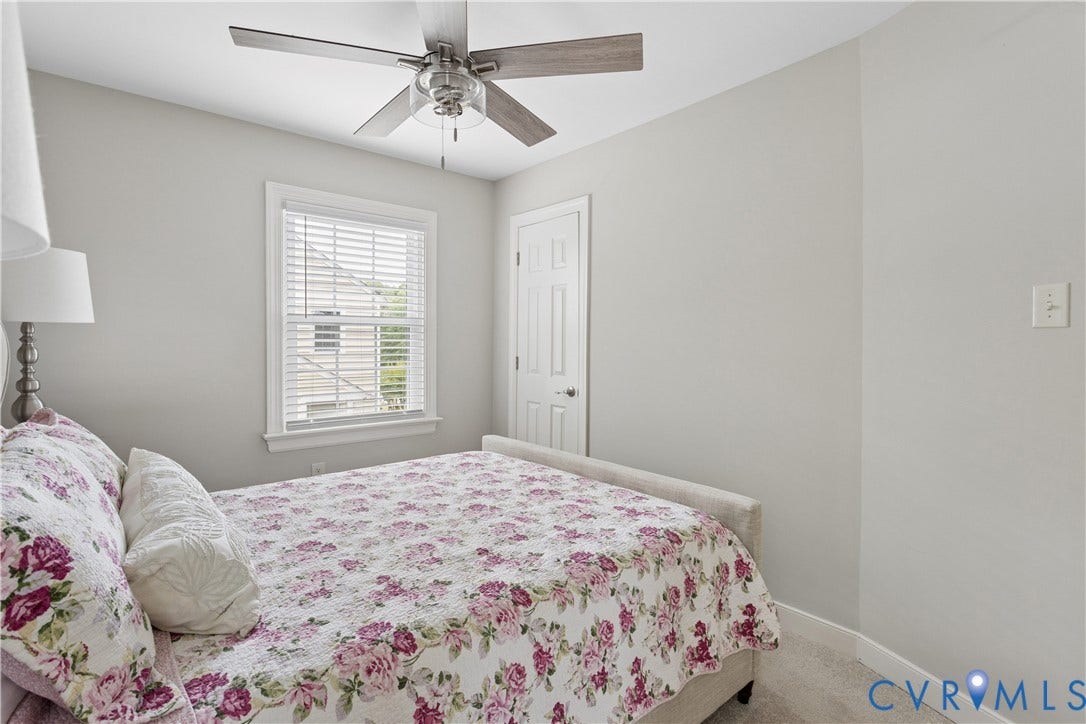 10100 Contessa Court, Glen Allen, VA 23060 Recessed window with white blinds, neutral wall paint, ceiling fan with light fixture, and white paneled door