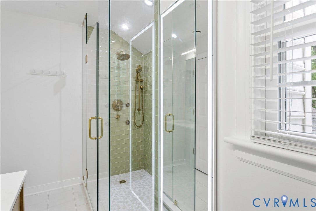 10100 Contessa Court, Glen Allen, VA 23060 Glass-enclosed shower featuring subway tile surround, multiple shower heads, and brass fixtures