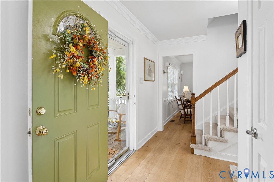 10100 Contessa Court, Glen Allen, VA 23060 Entryway featuring a paneled door with an arched glass insert, light wood-finish flooring, a carpeted staircase with wood handrail, and white trim throughout