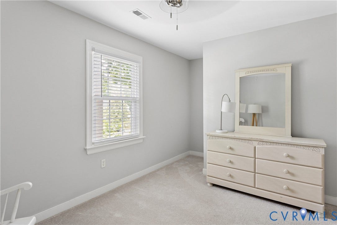 10100 Contessa Court, Glen Allen, VA 23060 Interior room featuring neutral wall paint, a single window with blinds, soft gray carpeting, and a ceiling fan with integrated lighting