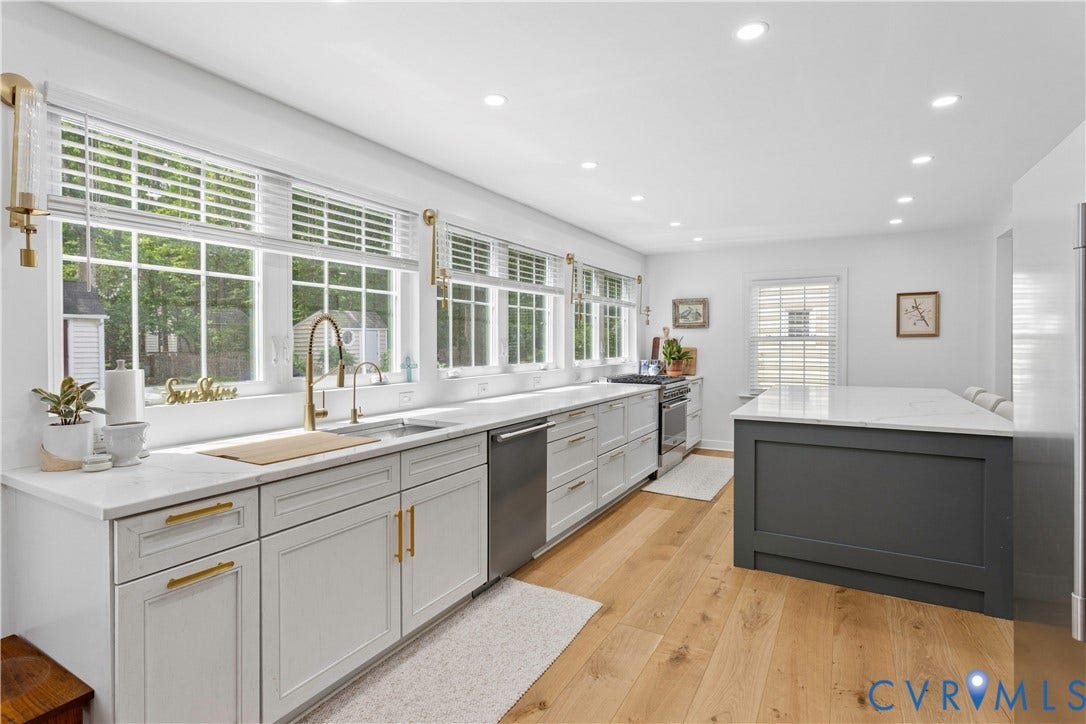 10100 Contessa Court, Glen Allen, VA 23060 Bright kitchen featuring an expansive window line, white shaker-style cabinetry with gold-tone hardware, a deep basin sink with a gold-tone faucet, a stainless steel dishwasher, and wood-finish flooring