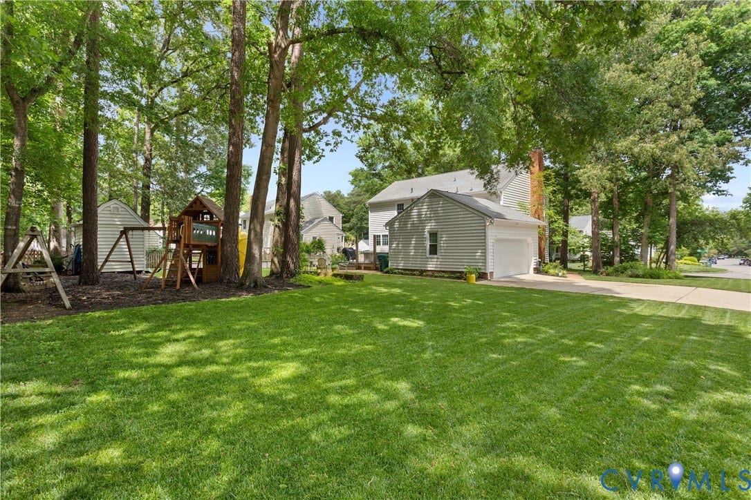 10100 Contessa Court, Glen Allen, VA 23060 Expansive rear lawn framed by mature trees, featuring a detached shed and a wood play structure