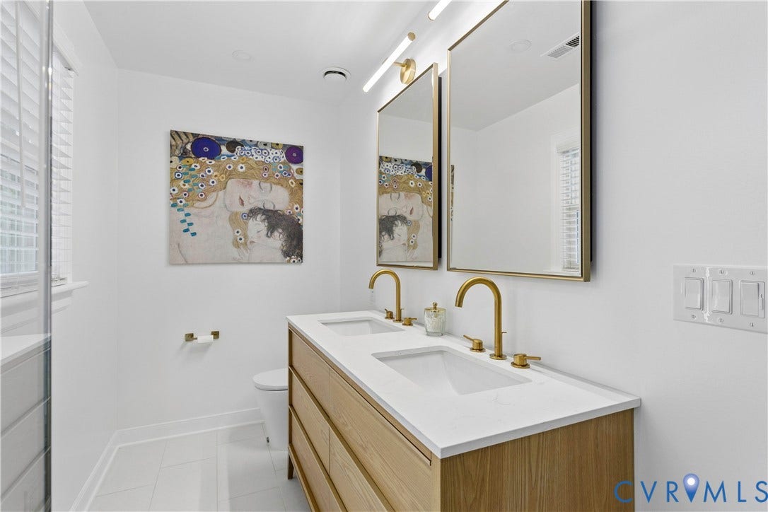 10100 Contessa Court, Glen Allen, VA 23060 Double vanity with light wood-finish cabinetry, white countertop, and gold-tone fixtures