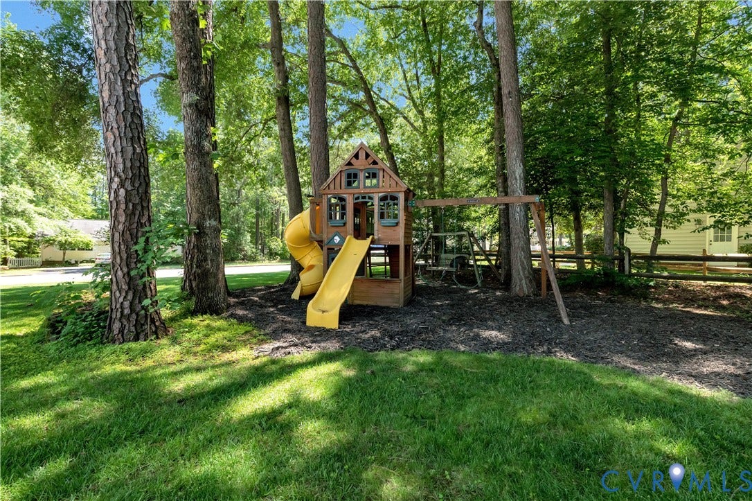 10100 Contessa Court, Glen Allen, VA 23060 Private backyard featuring a wooden playset with two yellow slides and a swing set