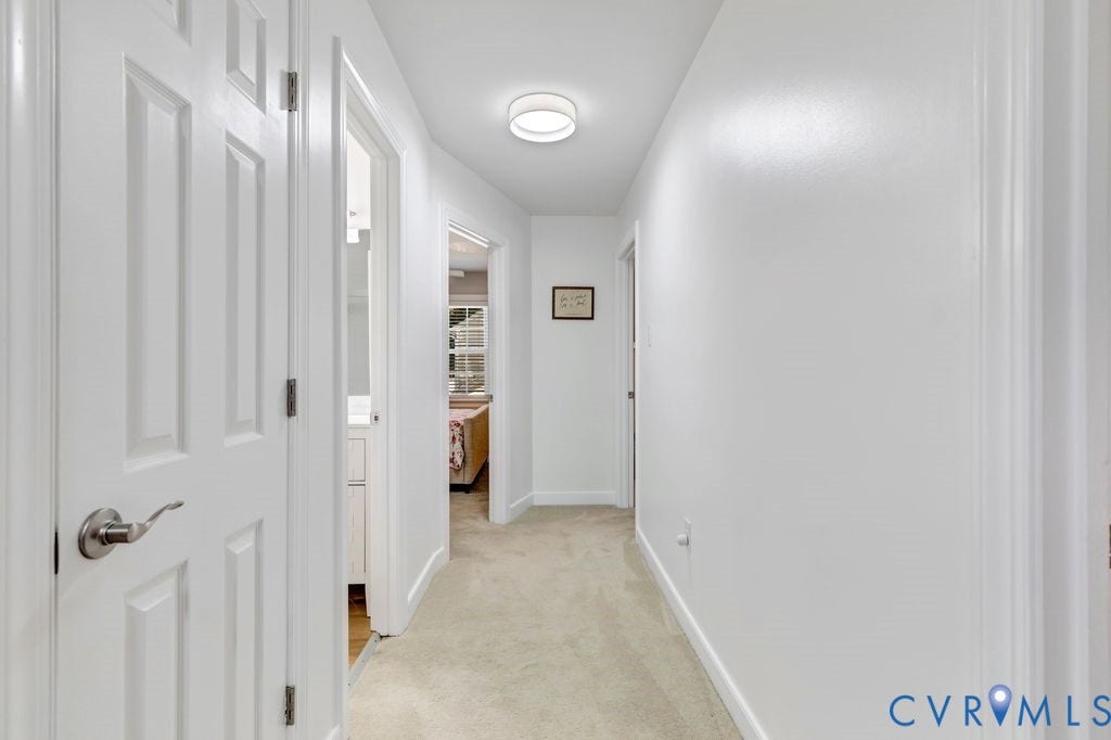 10100 Contessa Court, Glen Allen, VA 23060 Hallway featuring light-toned carpet flooring, white walls, and a contemporary flush-mount ceiling light