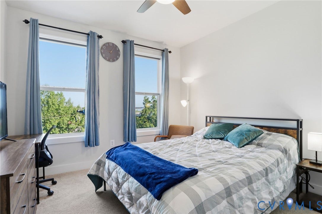 1121 N Lombardy Street, #B, Carver Square, Richmond, VA 23220 Bright bedroom featuring two large windows, a ceiling fan, and carpeted flooring