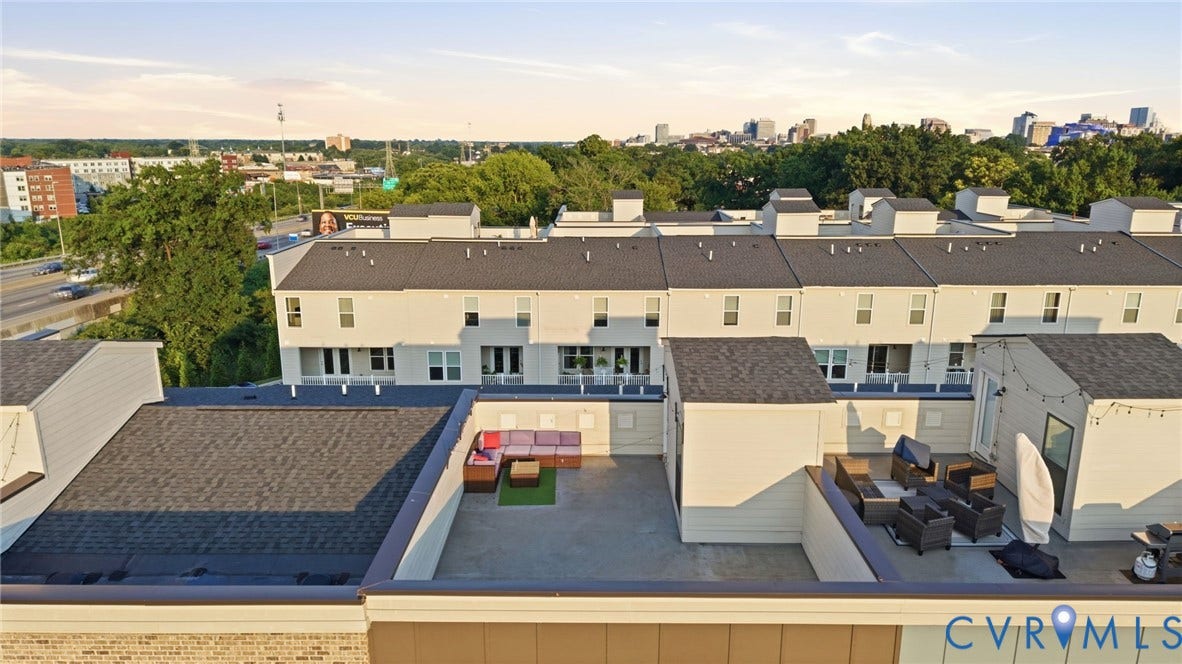 1121 N Lombardy Street, #B, Carver Square, Richmond, VA 23220 Rooftop patio with concrete flooring, low perimeter walls, and a partial city skyline