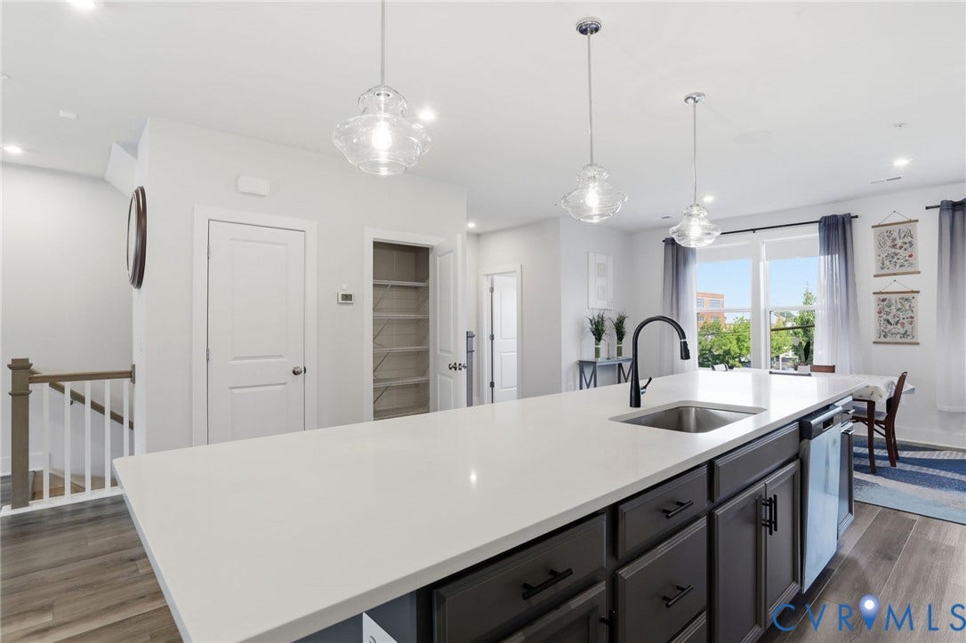 1121 N Lombardy Street, #B, Carver Square, Richmond, VA 23220 Kitchen island featuring a white countertop, undermount sink with a matte black faucet, and dark gray cabinetry