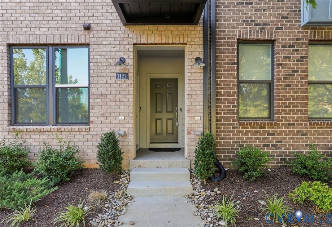 1121 N Lombardy Street, #B, Carver Square, Richmond, VA 23220 Brick exterior featuring a recessed entry with a dark door and overhead awning