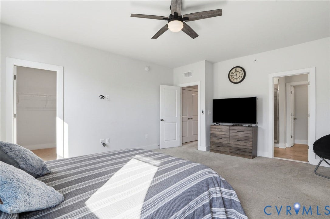 1121 N Lombardy Street, #B, Carver Square, Richmond, VA 23220 Carpeted bedroom featuring a ceiling fan with light, white walls, and multiple door openings