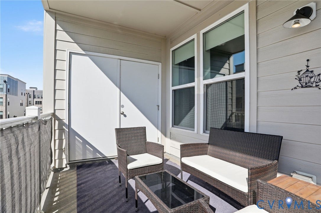 1121 N Lombardy Street, #B, Carver Square, Richmond, VA 23220 Outdoor Private Balcony featuring a textured privacy screen, exterior siding, and a pair of large windows.