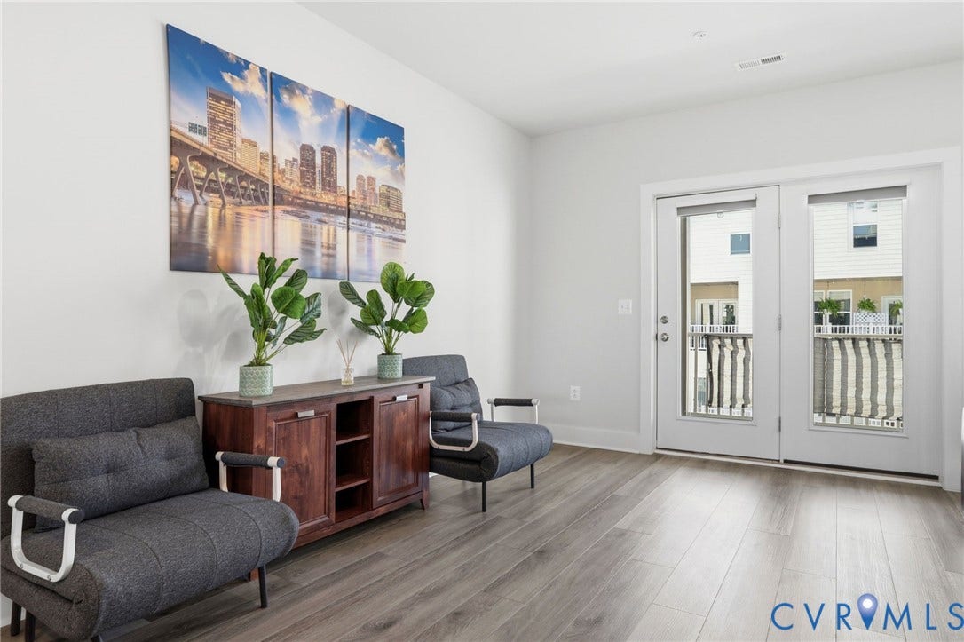 1121 N Lombardy Street, #B, Carver Square, Richmond, VA 23220 Family Room with light gray wood-finish flooring complements the neutral wall color