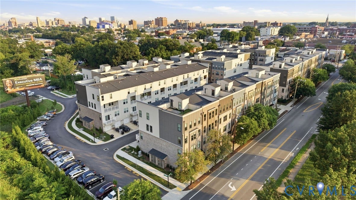 1121 N Lombardy Street, #B, Carver Square, Richmond, VA 23220 Modern townhome development featuring multi-story facades with varied finishes, private balconies, and integrated garage spaces