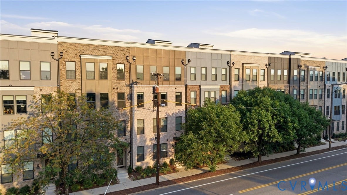1121 N Lombardy Street, #B, Carver Square, Richmond, VA 23220 Modern townhome complex featuring multi-story facades with varied brick, siding, and paneling materials