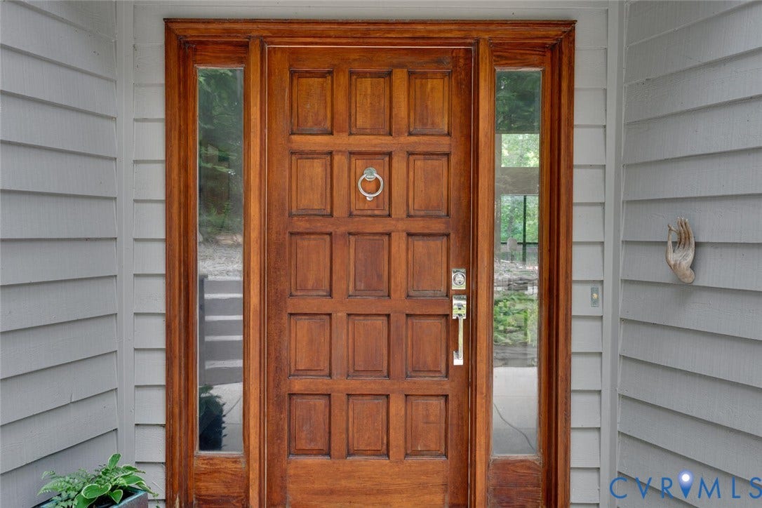 1474 Timber Ridge, Maidens, VA 23102 Panel-style wood-finish entry door with coordinating sidelights and a decorative door knocker
