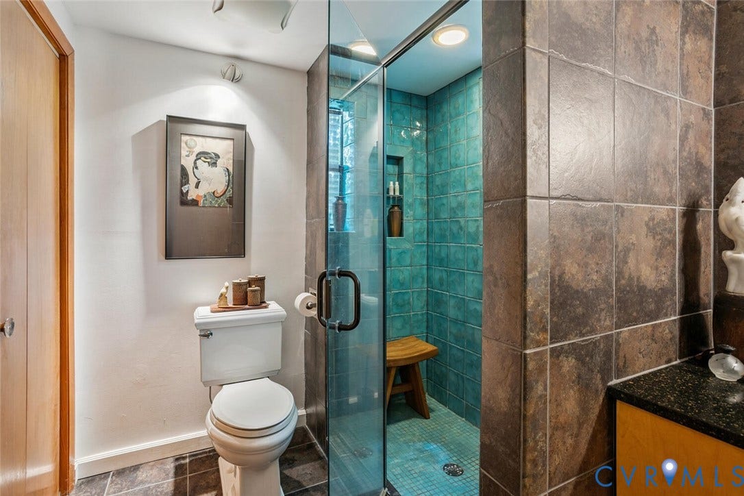 1474 Timber Ridge, Maidens, VA 23102 Walk-in shower with clear glass enclosure, integrated lighting, and teal tile surround