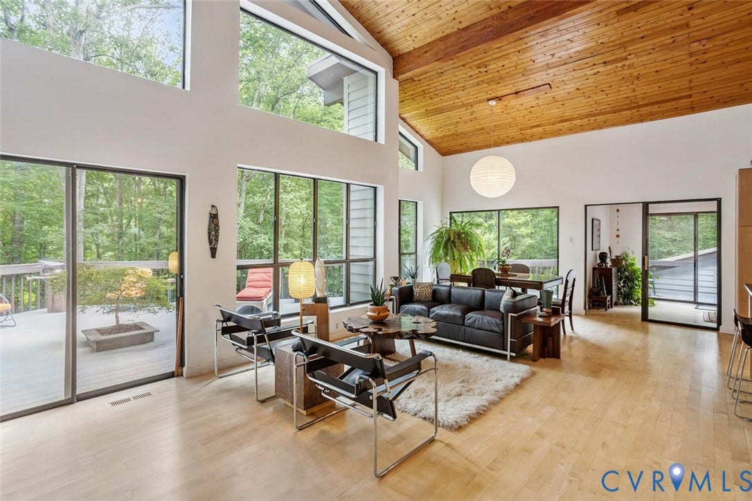 1474 Timber Ridge, Maidens, VA 23102 Vaulted wood-finish ceiling with exposed beams, expansive window walls, light wood-finish flooring, and multiple glass sliding doors providing exterior access