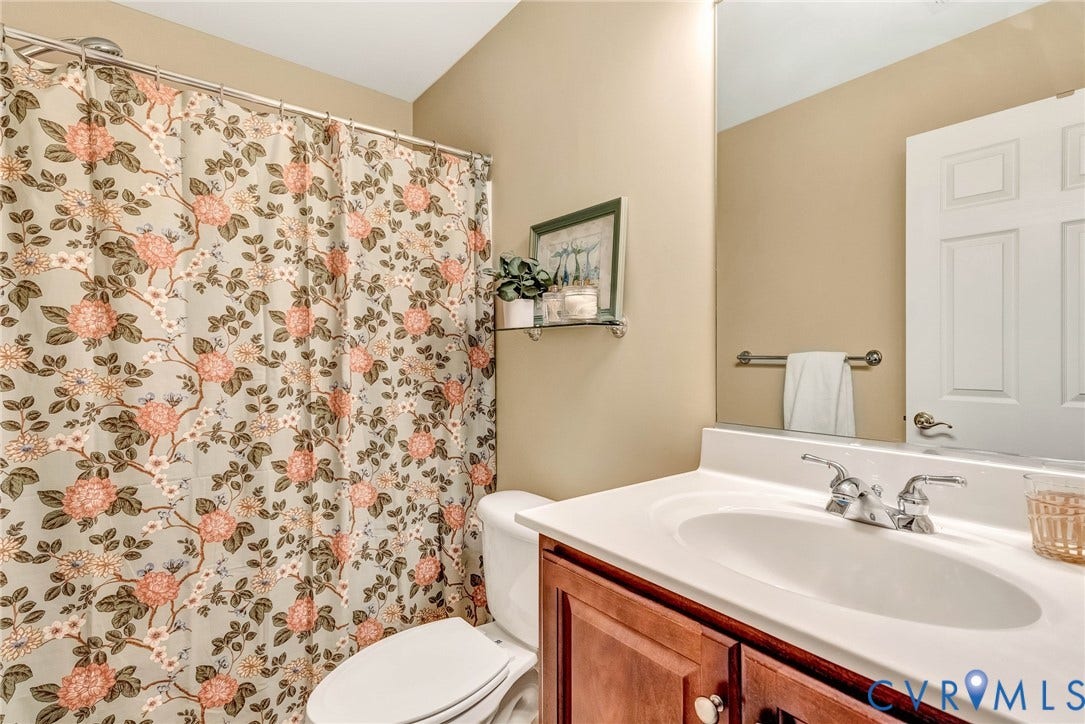 201 Maymont Way, Manakin Sabot, Manakin Sabot, VA 23103 The second floor hall bath has a tub/ shower combination with ceramic tile, ceramic tile floors, and raised vanity with cherry wood cabinets.