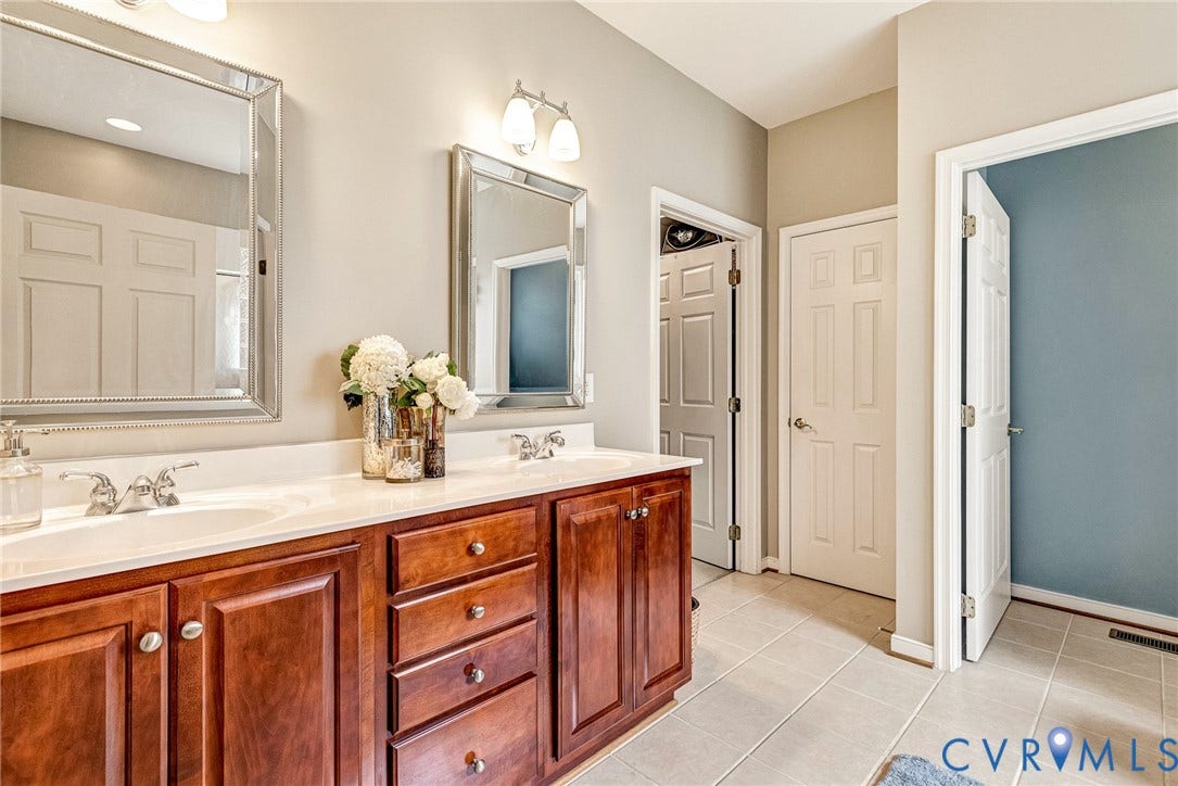201 Maymont Way, Manakin Sabot, Manakin Sabot, VA 23103 Adjacent to the primary bedroom is the spacious bathroom with 2 sinks in a raised vanity, glass enclosed shower, separate soking tub, and private toilet.