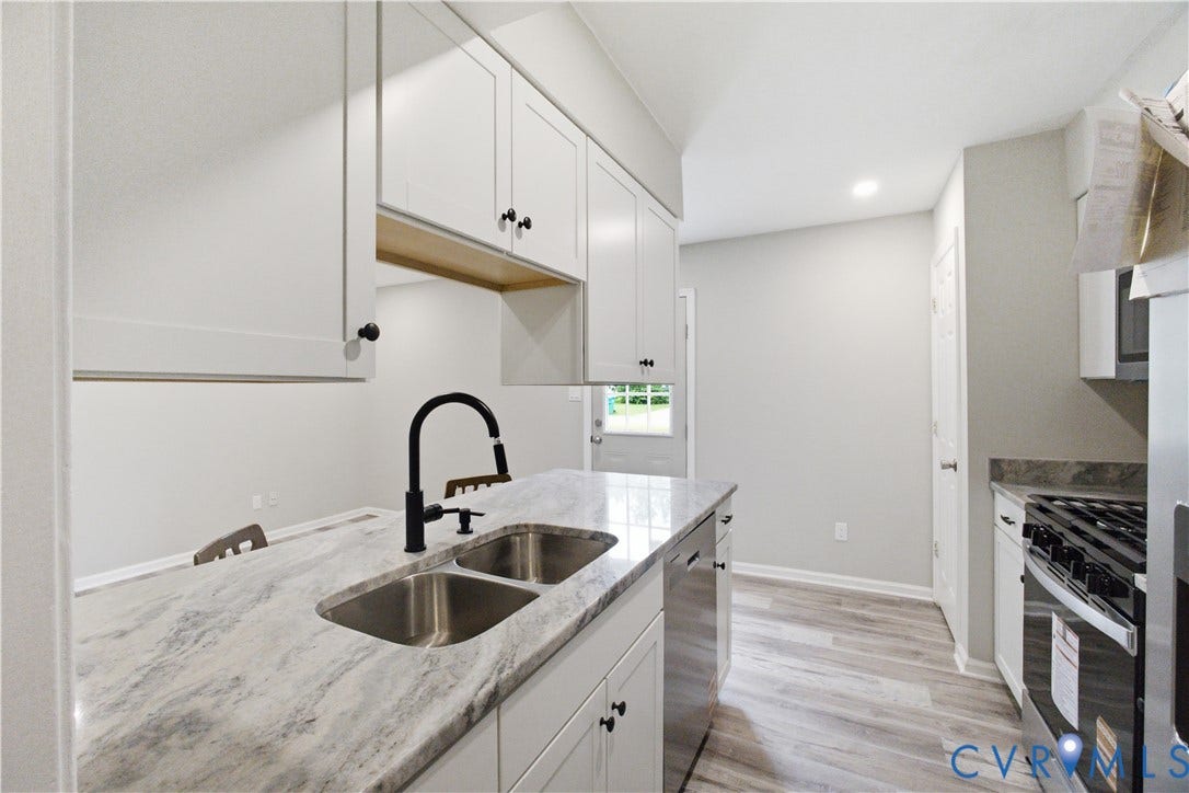 1304 Idlewood Avenue, Randolph, Richmond, VA 23220 Kitchen featuring an island with double stainless steel sinks and a matte black faucet