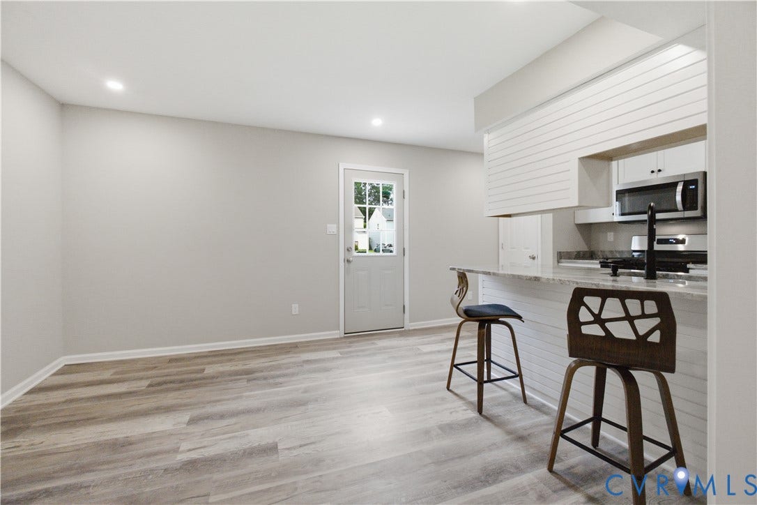 1304 Idlewood Avenue, Randolph, Richmond, VA 23220 Open-concept living space with wood-finish flooring, recessed lighting, and a white interior door with glass inserts