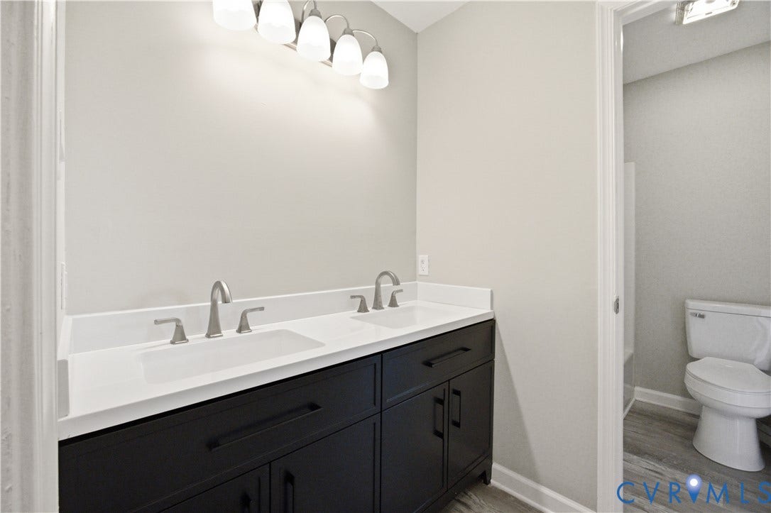 1304 Idlewood Avenue, Randolph, Richmond, VA 23220 Dual vanity featuring white countertops, undermount sinks, and brushed nickel hardware