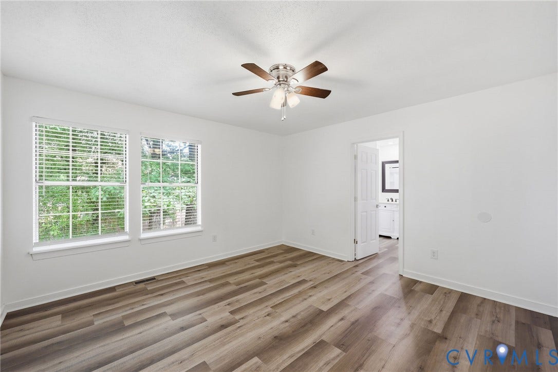 4217 Lipes Court, Glen Allen, VA 23223 Spacious room featuring wood-finish flooring, two windows, and a ceiling fan with integrated lighting