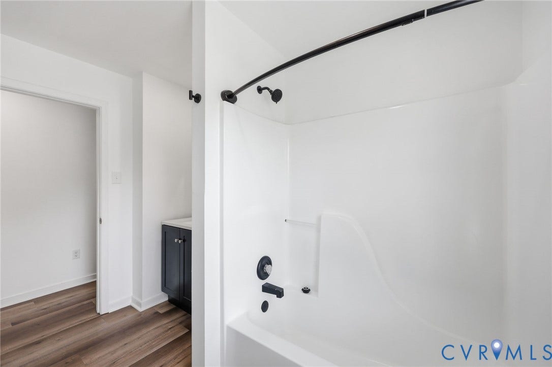 4217 Lipes Court, Glen Allen, VA 23223 White shower enclosure with matte black fixtures, integrated soap dish, and curved shower rod