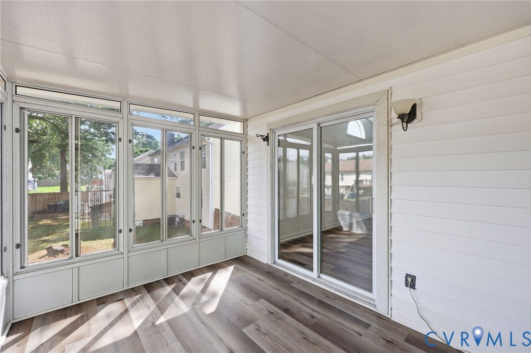 4217 Lipes Court, Glen Allen, VA 23223 Enclosed sunroom featuring wood-finish flooring, white horizontal siding, a white sliding glass door, and multiple window panels