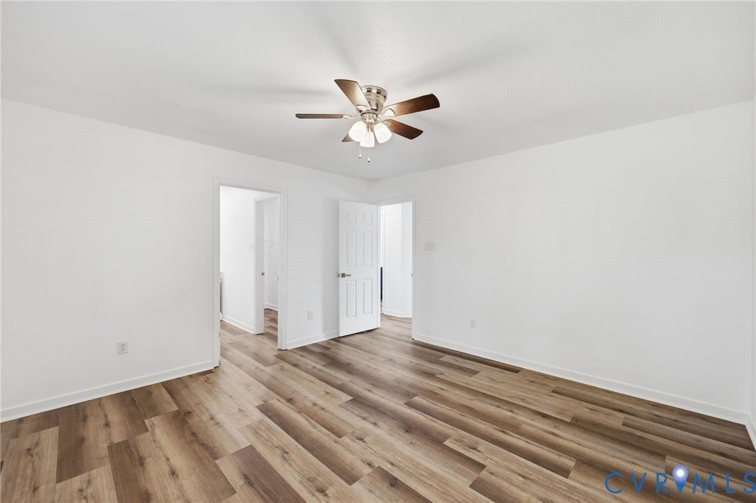 4217 Lipes Court, Glen Allen, VA 23223 Spacious room featuring wood-finish flooring, crisp white walls, and a ceiling fan with integrated lighting