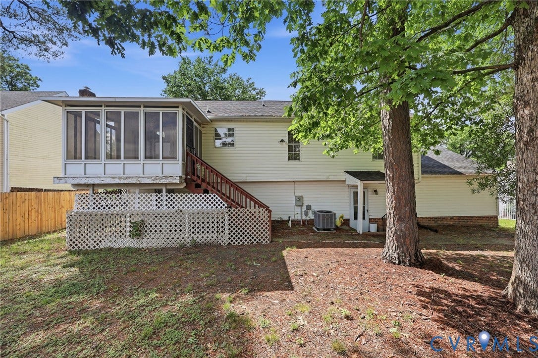 4217 Lipes Court, Glen Allen, VA 23223 Rear exterior featuring a screened porch with a white railing system, exterior stairs with wood-finish treads, and a fenced perimeter