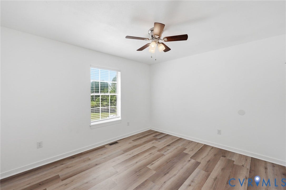 4217 Lipes Court, Glen Allen, VA 23223 Spacious interior room featuring wood-finish flooring, white walls, and a ceiling fan with integrated lighting