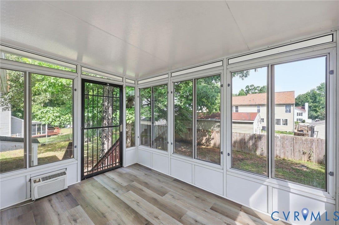 4217 Lipes Court, Glen Allen, VA 23223 Sunroom featuring wood-finish flooring, white paneling, multiple clear windows, a black security screen door, and a built-in air conditioning unit