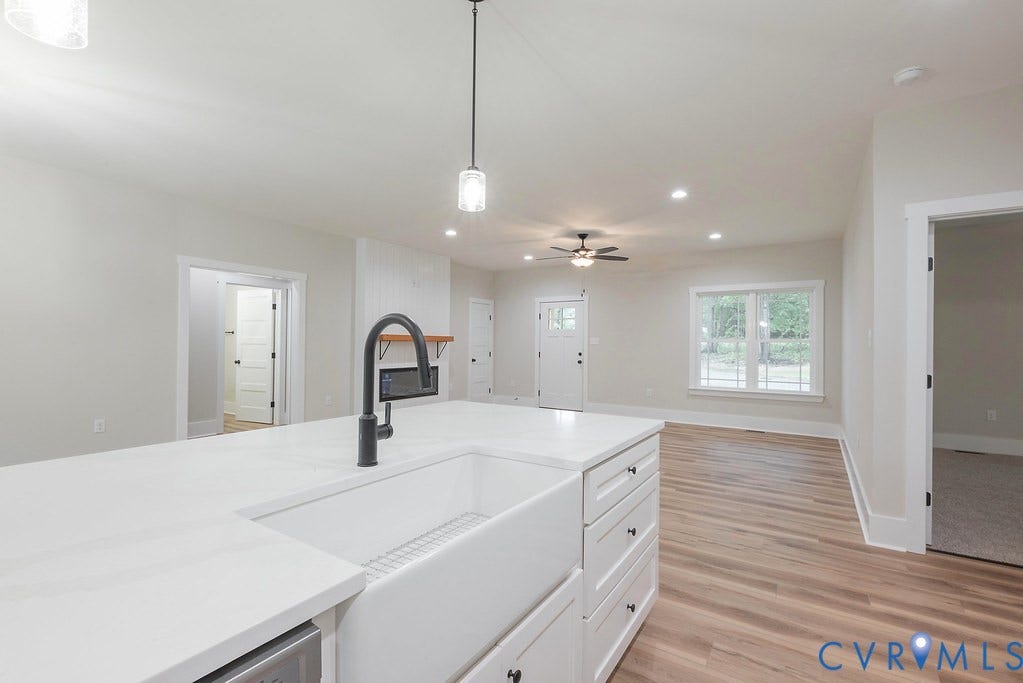 1220 Jefferson Highway, Moseley Estates, Louisa, VA 23093 Kitchen island featuring a white apron front sink with a matte black faucet and white countertop