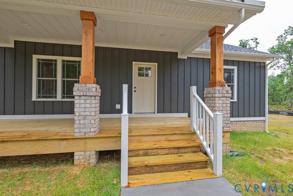 1220 Jefferson Highway, Moseley Estates, Louisa, VA 23093 Front porch with natural wood decking and steps, white railings, and a concrete landing