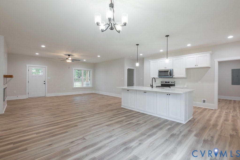 1220 Jefferson Highway, Moseley Estates, Louisa, VA 23093 Open-concept living space featuring wood-finish flooring, recessed lighting, and a contemporary chandelier