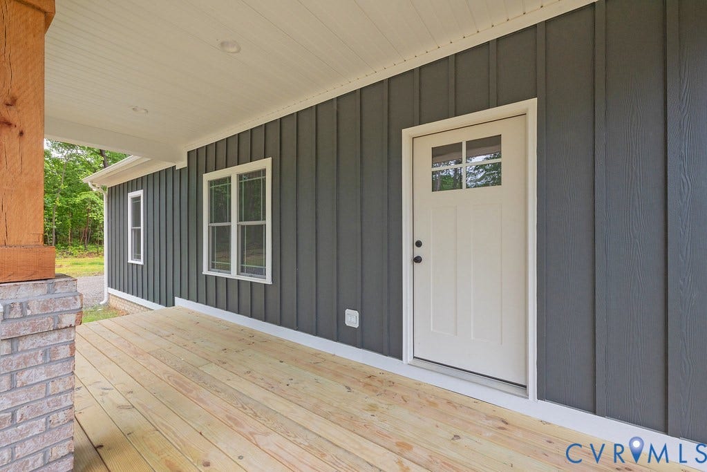 1220 Jefferson Highway, Moseley Estates, Louisa, VA 23093 Covered porch featuring natural wood flooring, board and batten siding, recessed lighting, and a brick base column