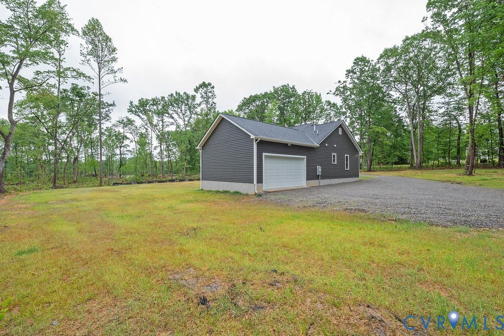 1220 Jefferson Highway, Moseley Estates, Louisa, VA 23093 Detached structure featuring dark gray siding, a white garage door, and a gray shingle roof