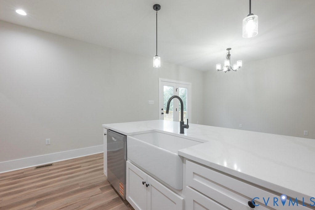 1220 Jefferson Highway, Moseley Estates, Louisa, VA 23093 Kitchen island featuring a white apron front sink, black gooseneck faucet, and white countertops