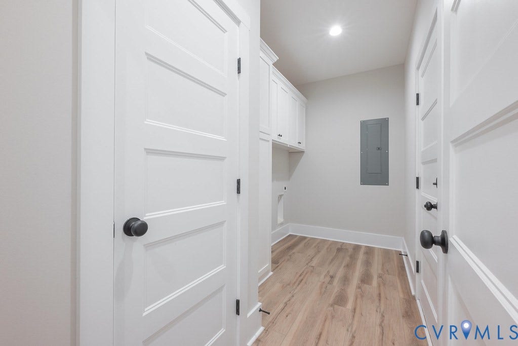 1220 Jefferson Highway, Moseley Estates, Louisa, VA 23093 Dedicated laundry space featuring built-in white cabinetry, wood-finish flooring, white trim, and recessed lighting