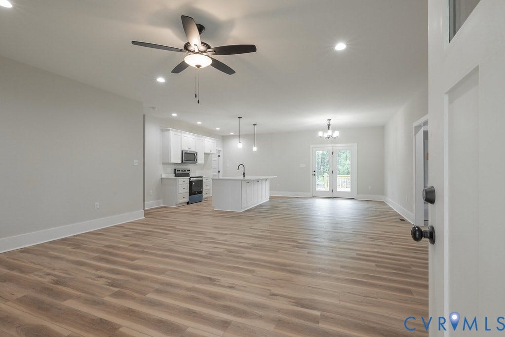 1220 Jefferson Highway, Moseley Estates, Louisa, VA 23093 Open-concept living space featuring wood-finish flooring, recessed lighting, and a contemporary ceiling fan