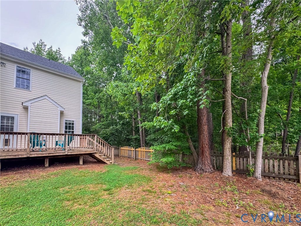 10517 Park Tree Place, Mountain Glen/ Glen Allen, Glen Allen, VA 23060 Rear exterior featuring a spacious wood deck with steps, a fenced yard, and established perimeter trees